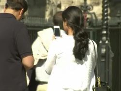 People using mobile phones in the street News Clip