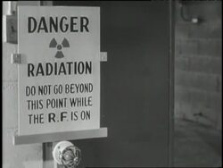 A group of young children hide under a desk as a siren and flashing light send an alert about radiation. News Clip
