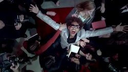 Hip-hop star throws hands in the air surrounded by fans and paparazzi at awards show Stock Footage