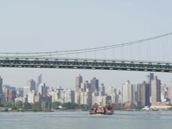 WS PAN View of boat moving from under Barge & Manhattan Bridge / New York, United States Stock Footage