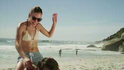 Young couple playing on beach Stock Footage
