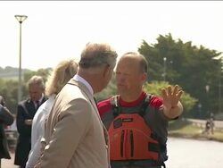 Charles and Camilla watch as people use canoes News Clip