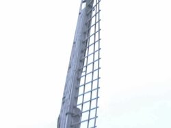 Close Up tilt-down - Large windmill blades are idle on a quaint windmill / Salzbergen, Germany Stock Footage