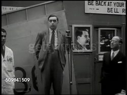 1945: ENGLAND LABORERS: WS British pedestrians on street, bicycles. HA WS Mechanics, single engine airplanes in hangar. DRAMATIZATION: WS Workers around speaker, microphone 'fulfill demand for homes, education, full employment & social security.' Instructional Video