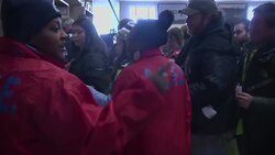 Fans sporting the team colors of Denver and Seattle streamed into MetLife Stadium for the Super Bowl on a mild winter evening Sunday, with the only minor disruption for commuting fans coming after a few people collapsed when the crowds overwhelmed a New J News Clip