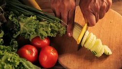 woman hand with knife cutting cucumbers on wooden board Stock Footage