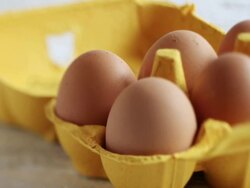 CU  PAN Shot of Hand taking egg from yellow carton / London, United Kingdom  Stock Footage