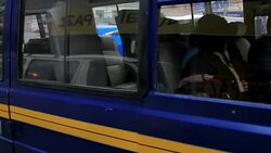 A shiny new bus pulls away from a Bolivian street market. Stock Footage