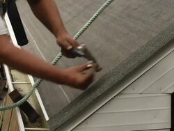 MS TU TD Shot of worker hammering edge shingle / Chelsea, Michigan, United States Stock Footage
