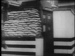 B/W 1940 soldier/air raid warden runs to police phone booth / London Blitz / educational Stock Footage