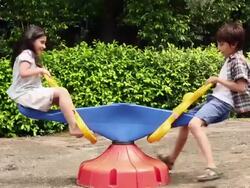 Boy and girl swinging in a Seesaw Stock Footage