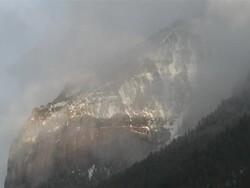 WS View of Clouds and Snow Rolling over Majestic Mountain Peaks in evening Light / Telluride, Colorado, United States Stock Footage