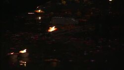 Diyas float and sparkle on a river during India's Diwali celebration. Stock Footage