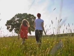 SLO MO Mother and daughter skipping in the meadow Stock Footage