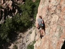 Handheld shot of a rock-climber looking for a secure hold. Stock Footage