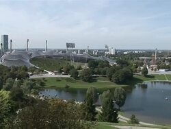 WS ZO PAN Roof of Olympic arena from 1972 Olympic games and park around with tele tower / Munich, Bavaria, Germany Stock Footage