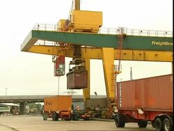 Crane lowering container on to lorry, Container Terminal, Southampton, UK Stock Footage