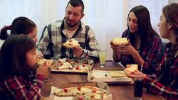 Family or friends sharing a pizza Stock Footage