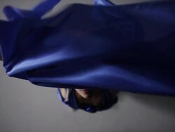 portrait of woman draped in blue silk fabric that floating around her in wind Stock Footage