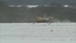 Snow ploughs clearing Manchester Airport runway News Clip