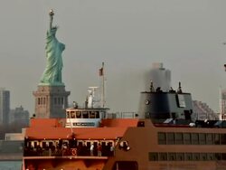 MS Statue of Liberty in Manhattan and ferry is seen going past / New York, United States Stock Footage