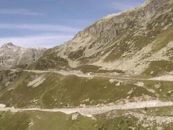 WS TS AERIAL View over Grimsel Pass road and Totesee reservoir with Summit of Sidelhorn / Grimsel Pass, Valais, Switzerland Stock Footage