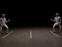Fencer on left lunges with his epee while his opponent ducks Stock Footage