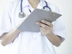 Female Doctor Writing Report on Clipboard Stock Footage