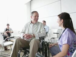 Nurse talking with senior patient in waiting room Stock Footage