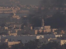 MS Black smoke coming out from fire burn near another part of town near mosuqe / Manamba ,Bahrain Stock Footage