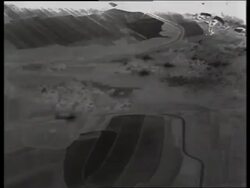 B/W 1950's AERIAL of shadows of airplanes on farmland / Korea / NO SOUND Stock Footage