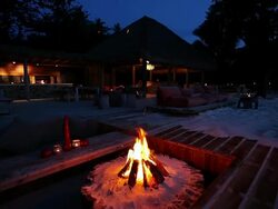 MS Fire burning outside restaurant at night / North Island, Seychelles Stock Footage