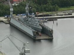 AERIAL Military ship in dry dock in naval base, Wilhelmshaven, Lower Saxony, Germany Stock Footage