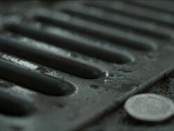 High Speed UK coins dropping onto drain Stock Footage