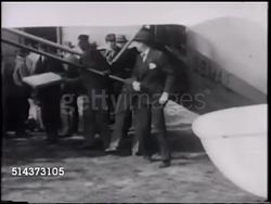 1920: COMMERCIAL AIRCRAFT: UNITED STATES: VS People gathered around unidentified aircraft, US Mail being loaded into airplane, passenger holding small mail envelopes & handed shotgun, plane beginning taxi on field. Instructional Video