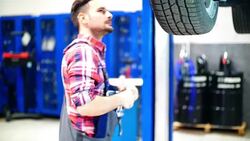 Car mechanic working under a vehicle. Stock Footage