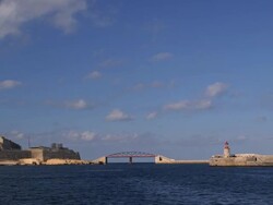 BREAKWATER BRIDGE AND RED GRAND HARBOUR LIGHTHOUSE Stock Footage