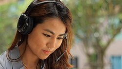 Young woman working in a call centre using a headset Stock Footage