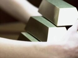 Young woman protecting gold ingots Stock Footage