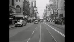 WS POV Exterior of buildings with shops, vehicles moving on street in city / Los Angeles, California, United States Stock Footage