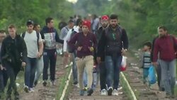 European Migration Crisis: Refugees Walk Along Train Tracks in Roszke News Clip