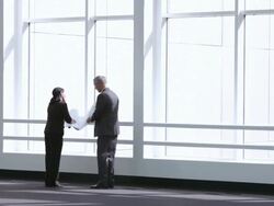  WS Business associates studying blueprint in front of sunny picture windows / Seattle, Washington, United States Stock Footage