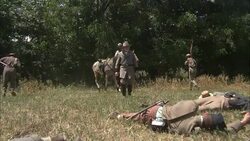 Confederate soldiers lie dead in a field as Confederate General Robert E. Lee assesses the losses. Stock Footage