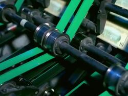 CU, Sheets of American ten dollar bills moving fast on conveyor, Washington DC, USA Stock Footage