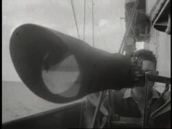 A Naval officer looks through binoculars while a soldier looks through a large telescope. News Clip