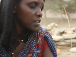 woman with tattooed face braiding straw Stock Footage