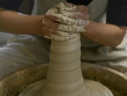 MS Shot of female potter shaping  pot from lump of clay on potters wheel at pottery / Kyoto, Japan Stock Footage