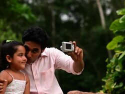 Man with his daughter taking picture with a digital camera  Stock Footage