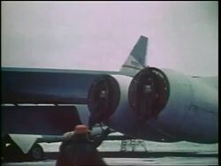 1960s two men removing covers from jet engines on military jet / Cold War / documentary Stock Footage