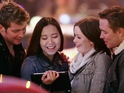 Young adults play with tablet in big city at night Stock Footage